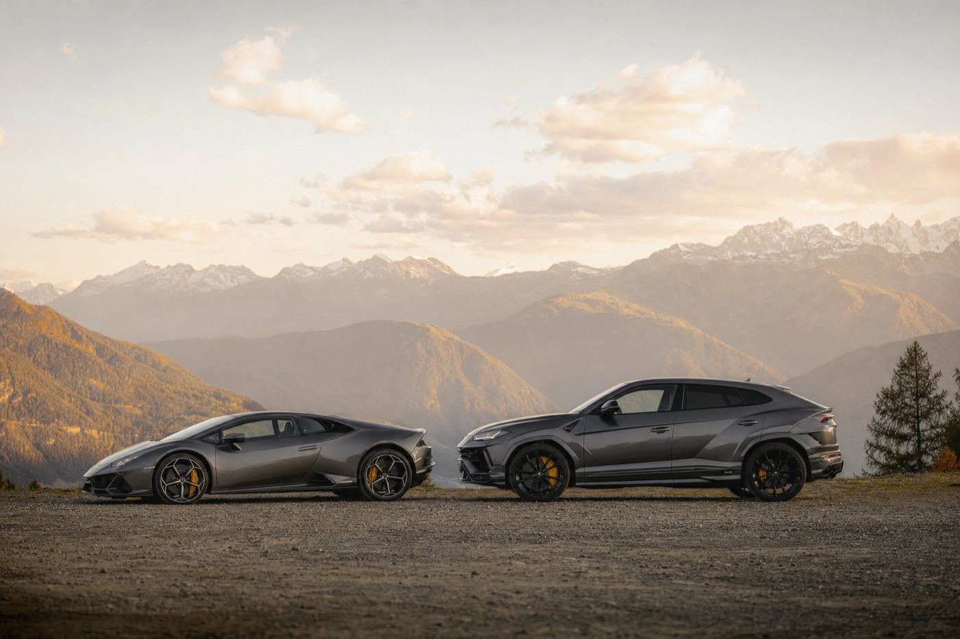 Our take on Huracán vs Urus rental: a Huracán and an Urus parked side by side at a scenic overlook at golden hour