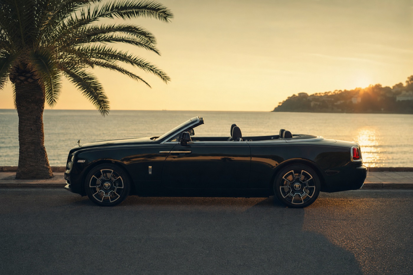 Popular rental cars: a Rolls-Royce Dawn convertible parked on a seafront promenade among palm trees