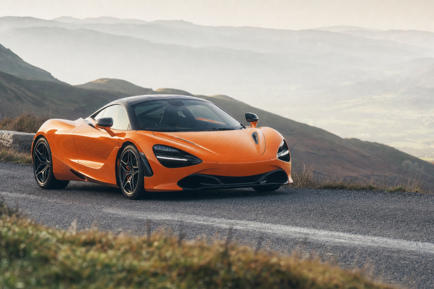 Most rented McLaren: a McLaren 720S on a mountain road with a hazy valley behind